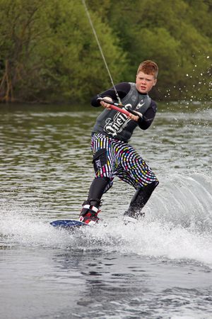Heron Lake, Wraysbury, UK April 25th 2010 a young boy Wake Boarder / wakeboarding at the British Disabled Water Ski-ing Association BDWSAのeditorial素材