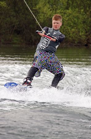Heron Lake, Wraysbury, UK April 25th 2010 a young boy Wake Boarder / wakeboarding at the British Disabled Water Ski-ing Association BDWSAのeditorial素材