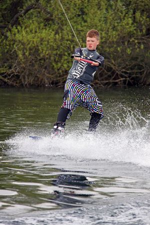 Heron Lake, Wraysbury, UK April 25th 2010: a young boy Wake Boarder / wakeboarding at the British Disabled Water Ski-ing Association BDWSAのeditorial素材