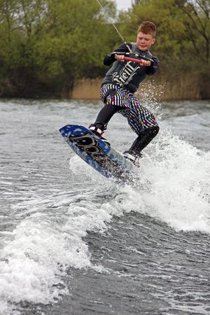Heron Lake, Wraysbury, UK April 25th 2010: a young boy Wake Boarder / wakeboarding at the British Disabled Water Ski-ing Association BDWSAのeditorial素材