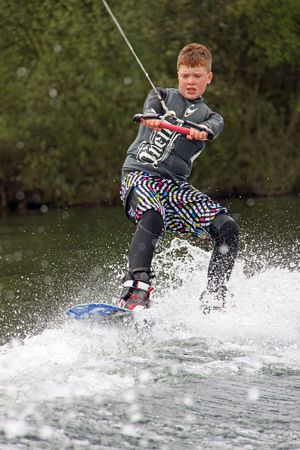 Heron Lake, Wraysbury, UK April 25th 2010: a young boy Wake Boarder / wakeboarding at the British Disabled Water Ski-ing Association BDWSAのeditorial素材