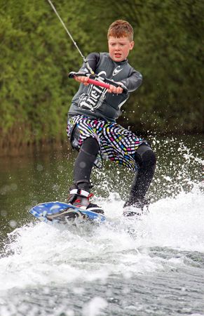 Heron Lake, Wraysbury, UK April 25th 2010: a young boy Wake Boarder / wakeboarding at the British Disabled Water Ski-ing Association BDWSAのeditorial素材