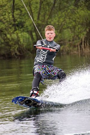 Heron Lake, Wraysbury, UK April 25th 2010: a young boy Wake Boarder / wakeboarding at the British Disabled Water Ski-ing Association BDWSAのeditorial素材