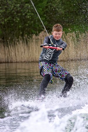 Heron Lake, Wraysbury, UK April 25th 2010: a young boy Wake Boarder / wakeboarding at the British Disabled Water Ski-ing Association BDWSAのeditorial素材