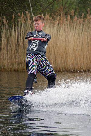 Heron Lake, Wraysbury, UK April 25th 2010: a young boy Wake Boarder / wakeboarding at the British Disabled Water Ski-ing Association BDWSAのeditorial素材