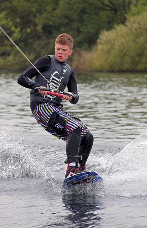 Heron Lake, Wraysbury, UK April 25th 2010: a young boy Wake Boarder / wakeboarding at the British Disabled Water Ski-ing Association BDWSAのeditorial素材