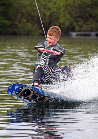 Heron Lake, Wraysbury, UK April 25th 2010: a young boy Wake Boarder / wakeboarding at the British Disabled Water Ski-ing Association BDWSAのeditorial素材