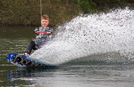 Heron Lake, Wraysbury, UK April 25th 2010: a young boy wakeboarding / surfing at the British Disabled Water Ski-ing Association BDWSAのeditorial素材