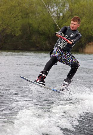 Heron Lake, Wraysbury, UK April 25th 2010: a young boy Wake Boarder / wakeboarding at the British Disabled Water Ski-ing Association BDWSAのeditorial素材