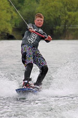 Heron Lake, Wraysbury, UK April 25th 2010: a young boy wakeboarding / surfing at the British Disabled Water Ski-ing Association BDWSAのeditorial素材