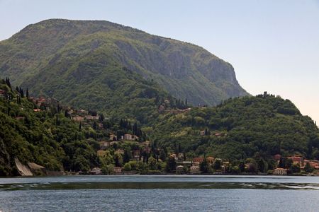 View of tree covered mountains and Lake Como in Italyの写真素材