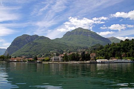 View of town settlement, blue sky, mountains and Lake Como in Italyの写真素材