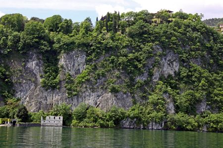Scene of tree covered mountain and Lake Como in Italyの写真素材