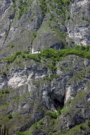 View of a church on a tree covered mountain at Lake Como in Italyの写真素材