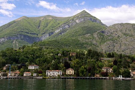 View of town settlement, blue sky, mountains and Lake Como in Italyの写真素材