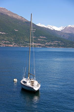 A sailing yacht on Lake Como, Italy with Treviso mountainsの写真素材