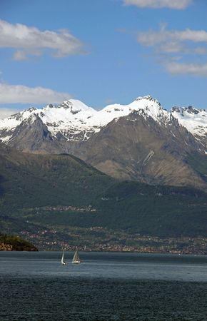 Scene of snow topped Treviso mountains at Lake Como in Italyの写真素材