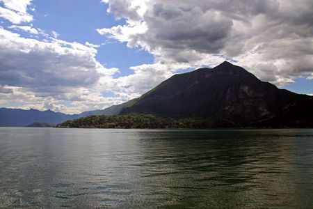 Scene of tree covered mountain and Lake Como in Italyの写真素材