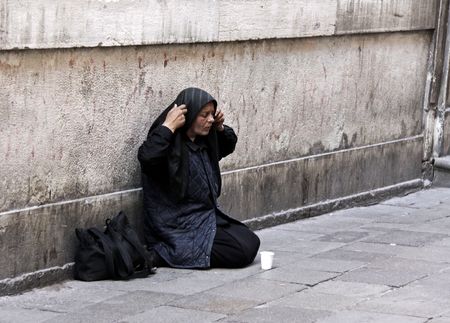 Verona, Veneto, Italy, May 22nd 2010 Near The Arena colosseum, a homeless woman begs for money in the streetのeditorial素材