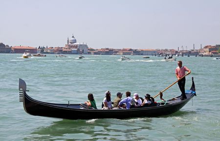 Venice, Italy, 21/5/10 Italian gondolier and tourists in a gondola near Saint Marks Squareのeditorial素材