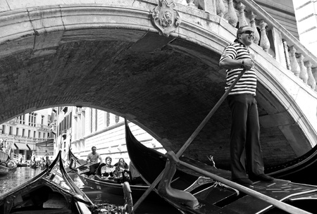 Venice, Italy, 21/5/10 Italian gondolier and tourist passengers in a gondola in a Venetian canalのeditorial素材