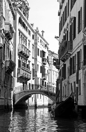 An Italian gondola boat and bridge over a canal in Venice , Italyの写真素材