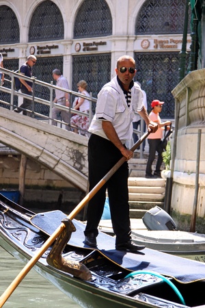 Venice, Italy, 21/5/10 Italian gondolier and tourist passengers in a gondola in a Venetian canalのeditorial素材