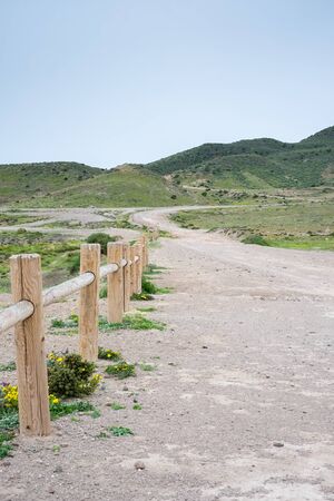 Sandy dirt road going into the hillsの写真素材