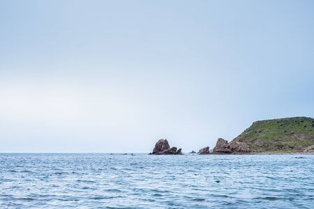 Rocks in the background from the Embarcadero beach in Los Escullos, on a cloudy day.の写真素材