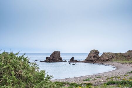 Beach with rocks in the background at Los Escullos, on a cloudy day.の写真素材
