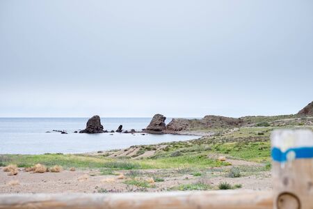 Beach with rocks in the background at Los Escullos, on a cloudy day.の写真素材