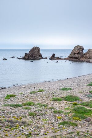Beach with rocks in the background at Los Escullos, on a cloudy day.の写真素材