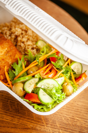 Concept of vegetarian and healthy eating. Cutlets from peas, salad, ogretsami, tomatoes, olives and porridge in eco-box of food starch. self-destructive dishes. Copy space, selective focusの写真素材