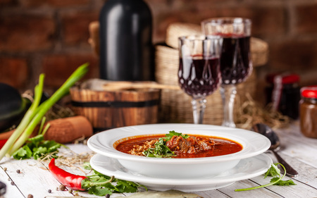 Traditional Georgian and Armenian cuisine. Tomato soup with rice Harcho of lamb, with walnut, garlic...