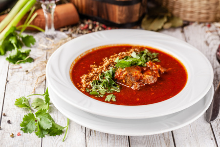 Traditional Georgian and Armenian cuisine. Tomato soup with rice Harcho of lamb, with walnut, garlic...