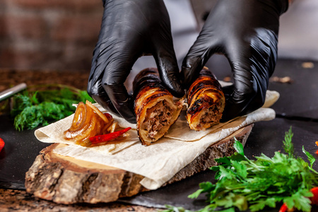 The concept of Georgian cuisine. Recipe for cooking meat lyulya kebab in the dough on the grill. Chef puts meat on a skewer.の写真素材