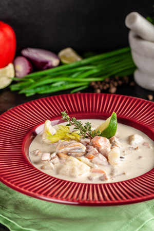 The concept of American cuisine. Clam chowder potato soup with sea food, mussels, salmon. Fish broth soup with milk. Serving dishes in the restaurant. copy spaceの写真素材