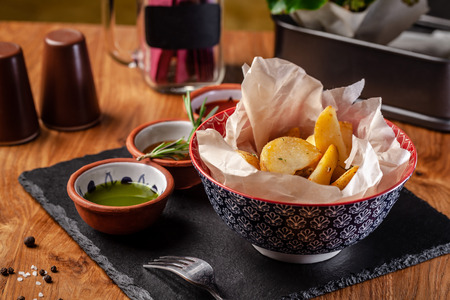 The concept of Mexican cuisine. Baked spicy potatoes with pepper, with different sauces, salsa, guacamole, chilli and shrimp. Background image. copy spaceの写真素材