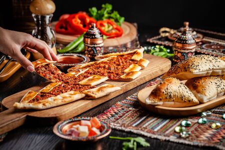Traditional Turkish cuisine. Turkish pizza Pita with meat. Turk Pidesi or  Sucuk Pide. Beautiful serving dishes in the restaurant. Background image. copy spaceの写真素材