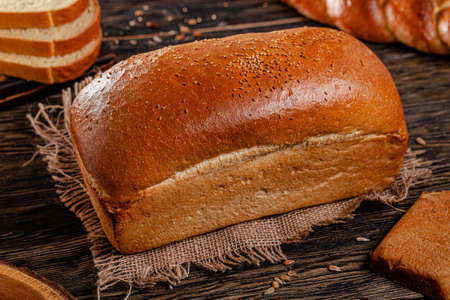 Assorted bread for catalan shooting. Long loaf, buns, baguette, pigtail, shaped. Bread on a wooden...
