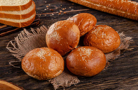 Assorted bread for catalan shooting. Long loaf, buns, baguette, pigtail, shaped. Bread on a wooden...