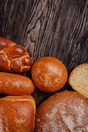 Assorted bread for catalan shooting. Long loaf, buns, baguette, pigtail, shaped. Bread on a wooden...