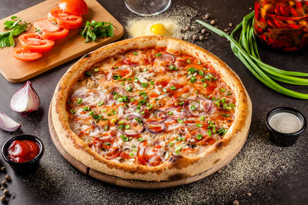 Italian Cuisine. Thin pizza with bacon, red onion, green onion and mushrooms in tomato sauce. Background image. copy spaceの写真素材