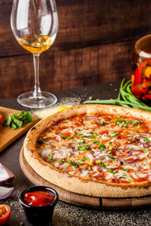 Italian Cuisine. Thin pizza with bacon, red onion, green onion and mushrooms in tomato sauce. Background image. copy spaceの写真素材
