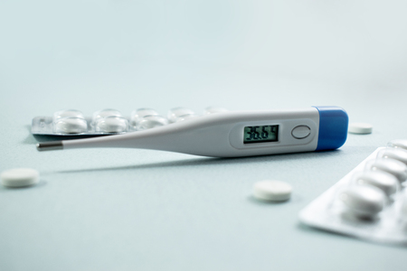 Medical background with multi-colored packs of pills. ?oncept pharmacy, clinic, drugs, headache medicine. Image on illness, flu, treatment. Image of a thermometer with a normal temperatureの写真素材