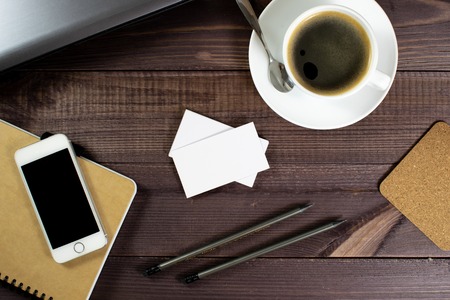 Flat lay, top view office table desk. Workspace with blank clip board, pencil, green leaf, and coffee cup on dark background. ?oncept for internet banners, marketing, promotion, business, startupの写真素材