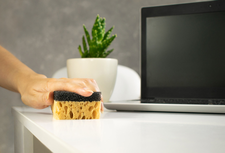 Image view above, flat lay detergent. The concept of Service for cleaning apartments and premises, cleanliness. Hand rubs the dust off the table. Housewife, maid cleans the house.の写真素材