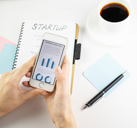 Minimalistic workplace concept, with a stationery, pen and business work records on a white...