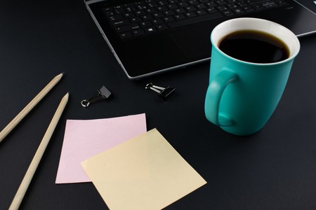 Minimalistic workplace concept, with a smartphone, pen and business work records on a dark background. Image digital, marketing, design agency. Close up image.の写真素材