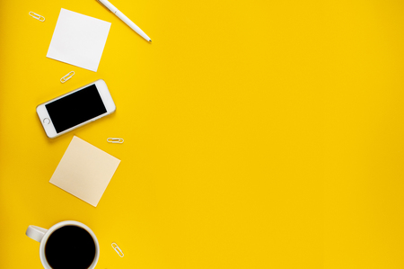 Minimalistic workplace concept, with a smartphone, pen and business work records on a dark background. Image digital, marketing, design agency. Top view. Flat lay styleの写真素材